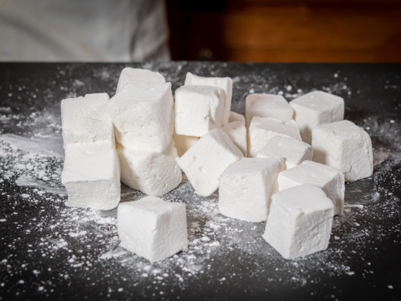 Pile of marshmallows cut in cubes on a countertop