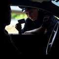 Police officer looking at driving licence card