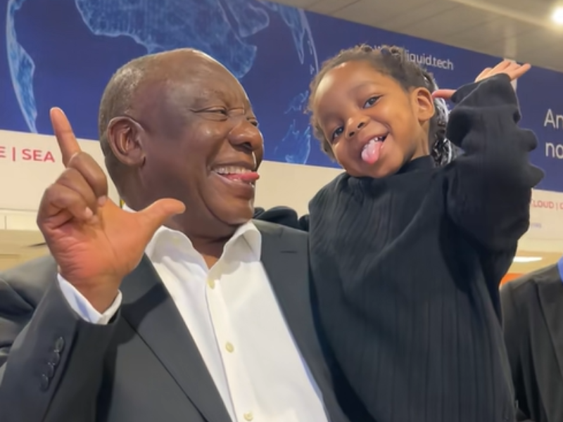 President Cyril Ramaphosa does a silly pose with a toddler