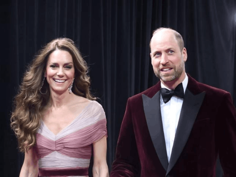Princess Catherine and Prince William posing in front of a Christmas tree