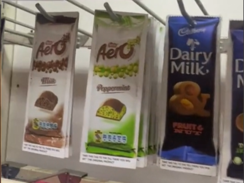 Print outs of chocolates hanging on a shelf at a South African retailer