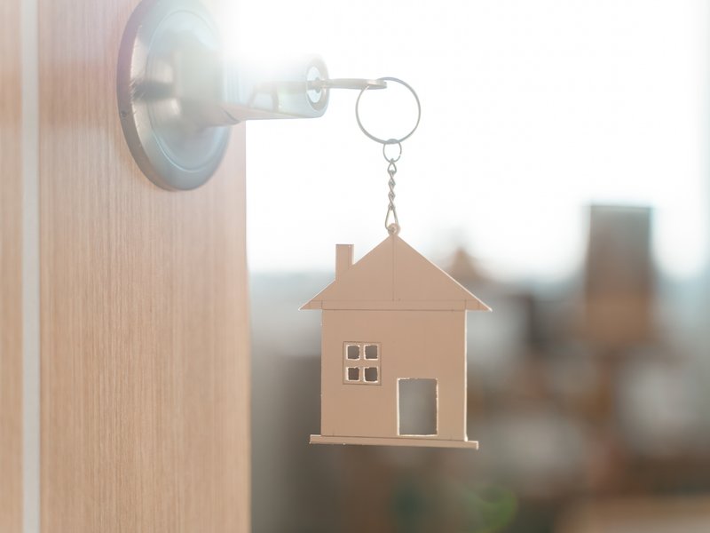 Door with key and home shaped keychain