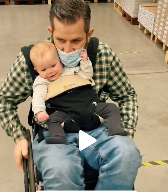 Quadriplegic father picks up his baby girl