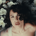 RAYE surrounded by large white flowers