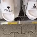 Racks of sandals with knockoff names