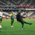 South African players watch as South African head coach Rassie Erasmus kicks the ball during warm up ahead of the international rugby union Test match between South Africa and Georgia