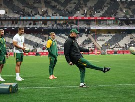 South African players watch as South African head coach Rassie Erasmus kicks the ball during warm up ahead of the international rugby union Test match between South Africa and Georgia