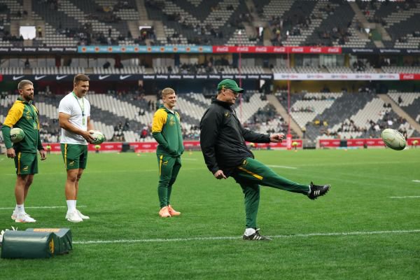 South African players watch as South African head coach Rassie Erasmus kicks the ball during warm up ahead of the international rugby union Test match between South Africa and Georgia