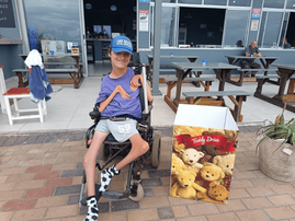 Reece Smith sitting on his wheelchair at the Amanzimtoti beach