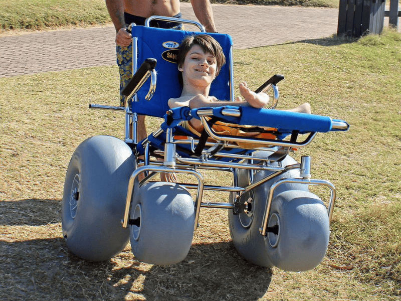 Reece Smith smiling as he sits on his wheels