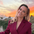 Reese Witherspoon wearing a maroon blazer