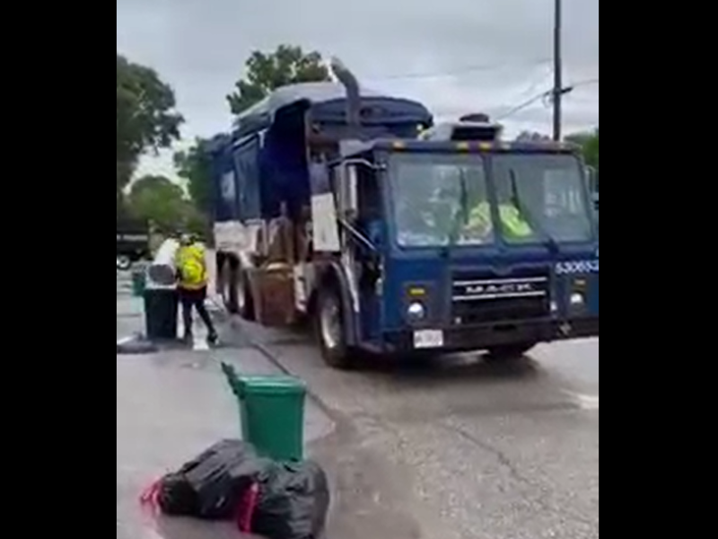 Refuse truck taking out the trash in Canada