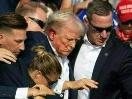 Republican candidate Donald Trump is seen with blood on his face