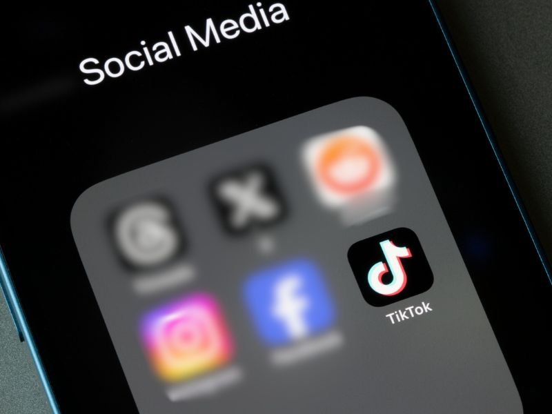 Social media folder on phone with focus on TikTok