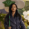 Rihanna carrying a giant white flower as an umbrella