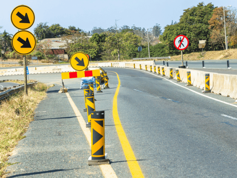 Road construction detour signs and barriers