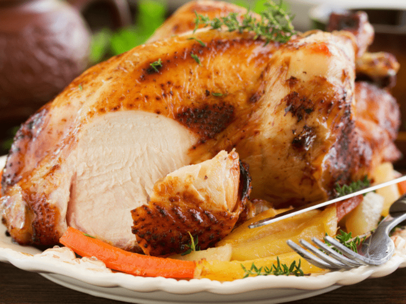 roast chicken on a white place with vegetables