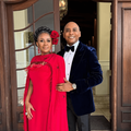 Romeo and Basestana Kumalo pose in front of a large wooden door