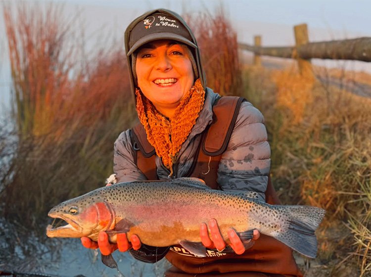 Roxanne Stegen braving the cold with a rainbow trout caught in the Midlands