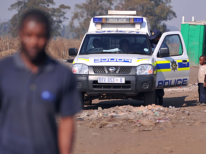 SAPS van in township.PNG