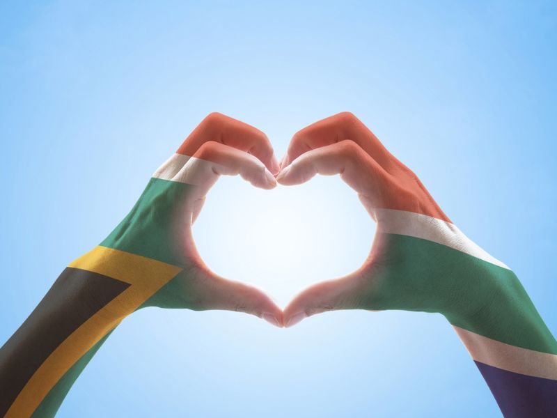 SA flag colours painted on hands making heart