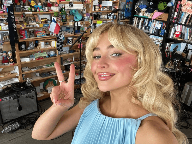 Sabrina Carpenter holding up a peace sign