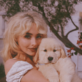 Sabrina Carpenter posing with a golden retriever puppy