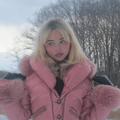 Sabrina Carpenter wearing a pink padded coat