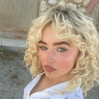 Sabrina Carpenter wearing her hair in blonde curls