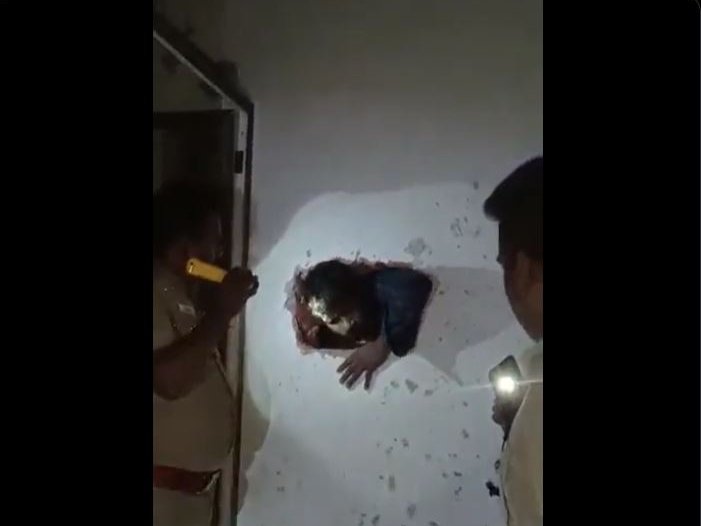 Two men drilled a hole in the wall of a liquor shop & were boozing inside when caught red handed by a patrol police.