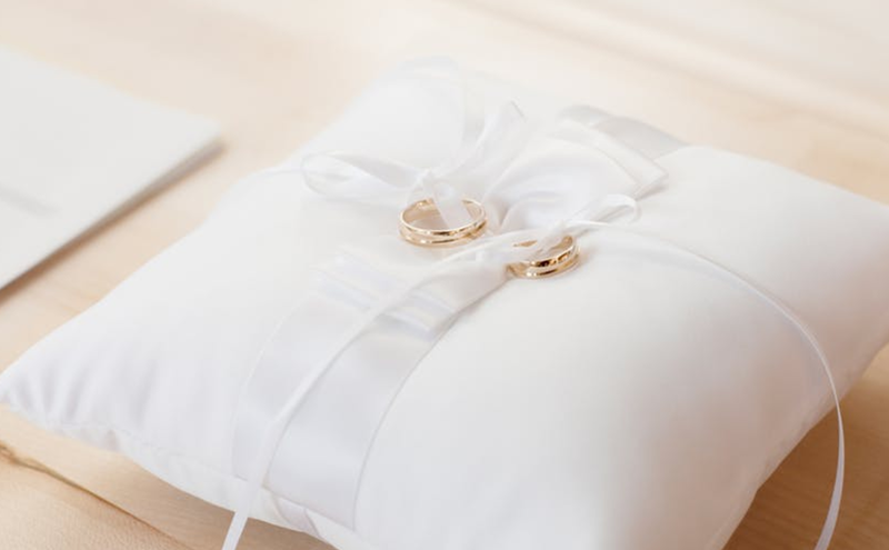 wedding rings on pillow pexels