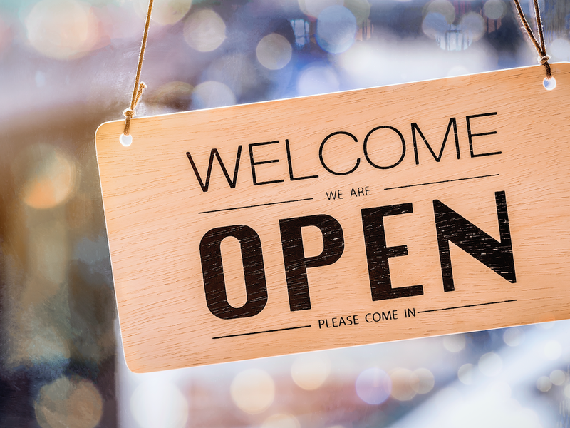 Wooden sign board hanging on door istock