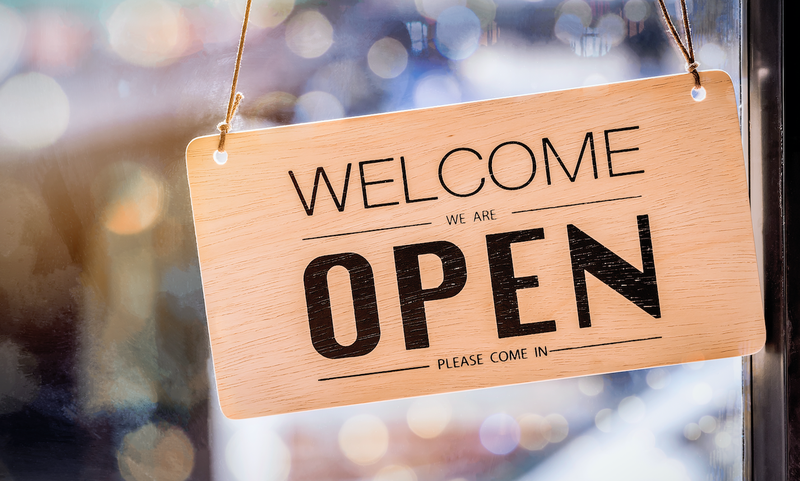 Wooden sign board hanging on door istock