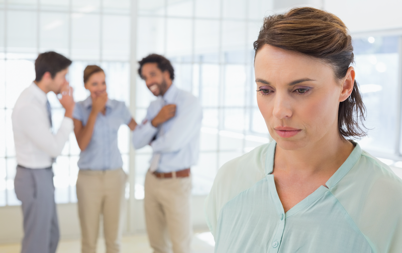 gossiping behind colleagues istock