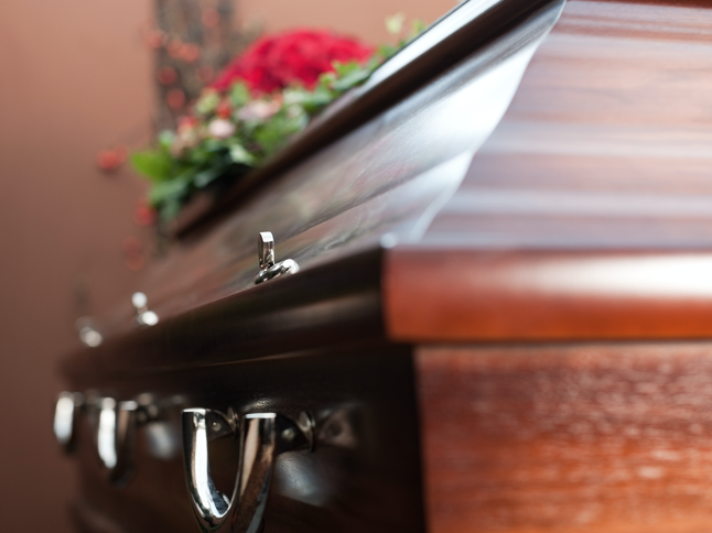 Coffin at funeral / iStock