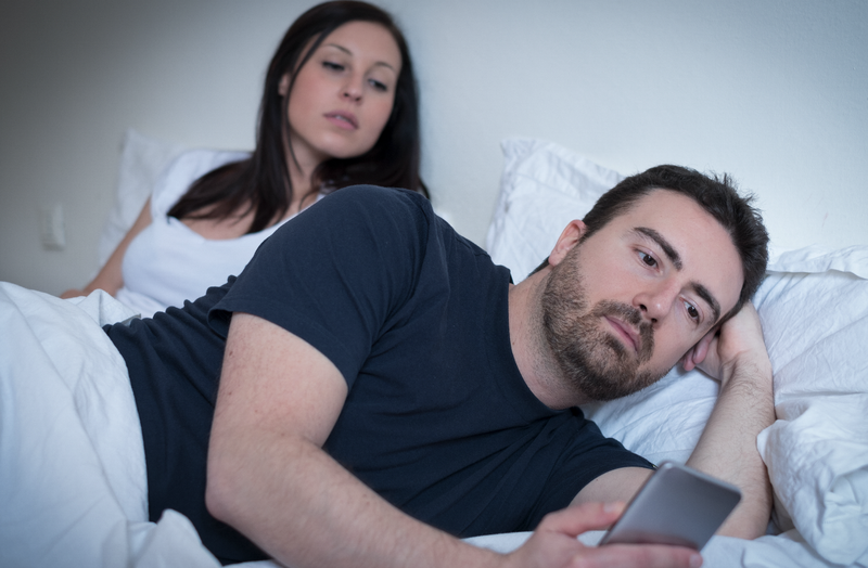 cellphone in bed / istock