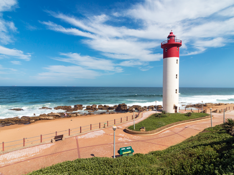 Lighthouse Against Blue Cloudy Coastal Seascape in Umhlanga / iStock