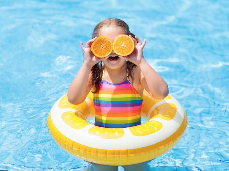 Little girl having fun in the pool / iStock