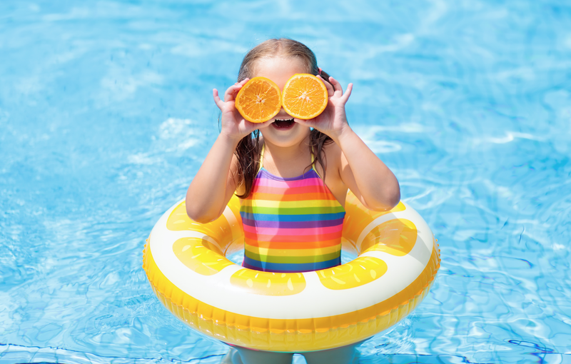 Little girl having fun in the pool / iStock