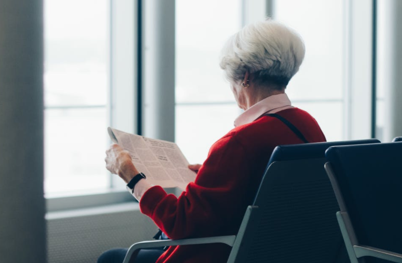 Elderly woman reading newspaper / Pexels