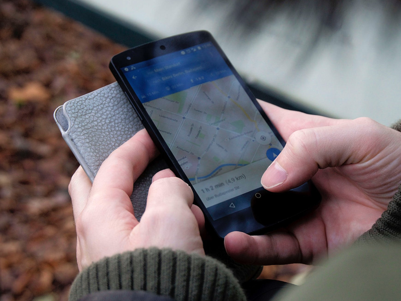 Person using Google Maps on smartphone / Pexels