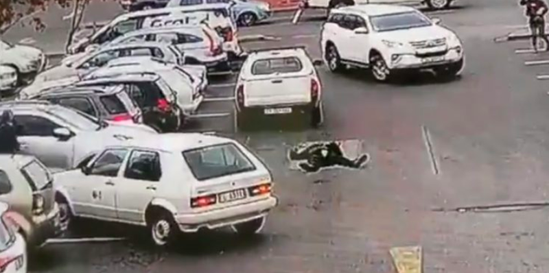 South African motorist run-down car guard in parking lot