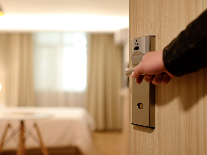 Person Holding on Door Lever Inside Room / Pexels