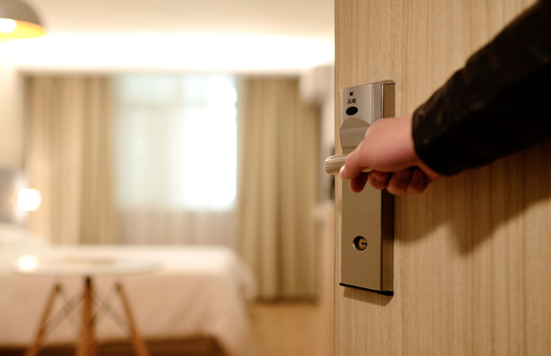 Person Holding on Door Lever Inside Room / Pexels