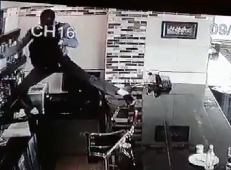 Man climbs over bar to steal booze