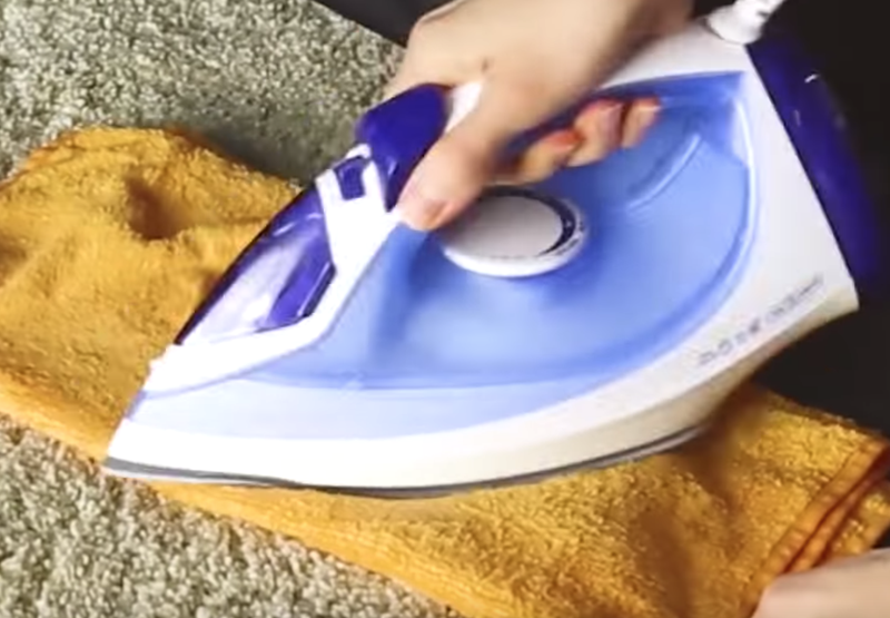 Ironing on a damp cloth / YouTube screenshot