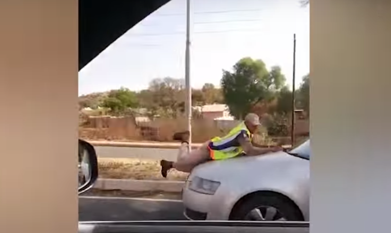 'Motorist drives off with officer on bonnet' / YouTube