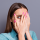 Close up studio photo portrait of embarrassed woman / iStock