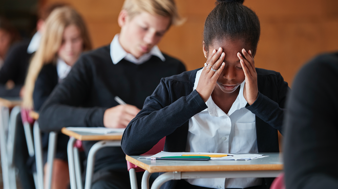 Student stressed out writing exams / iStock