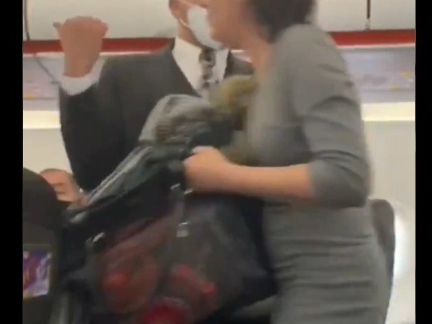Woman coughs on passengers